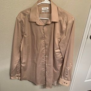 It’s a tan colored Calvin Klein wrinkle free large shirt! Slim fit